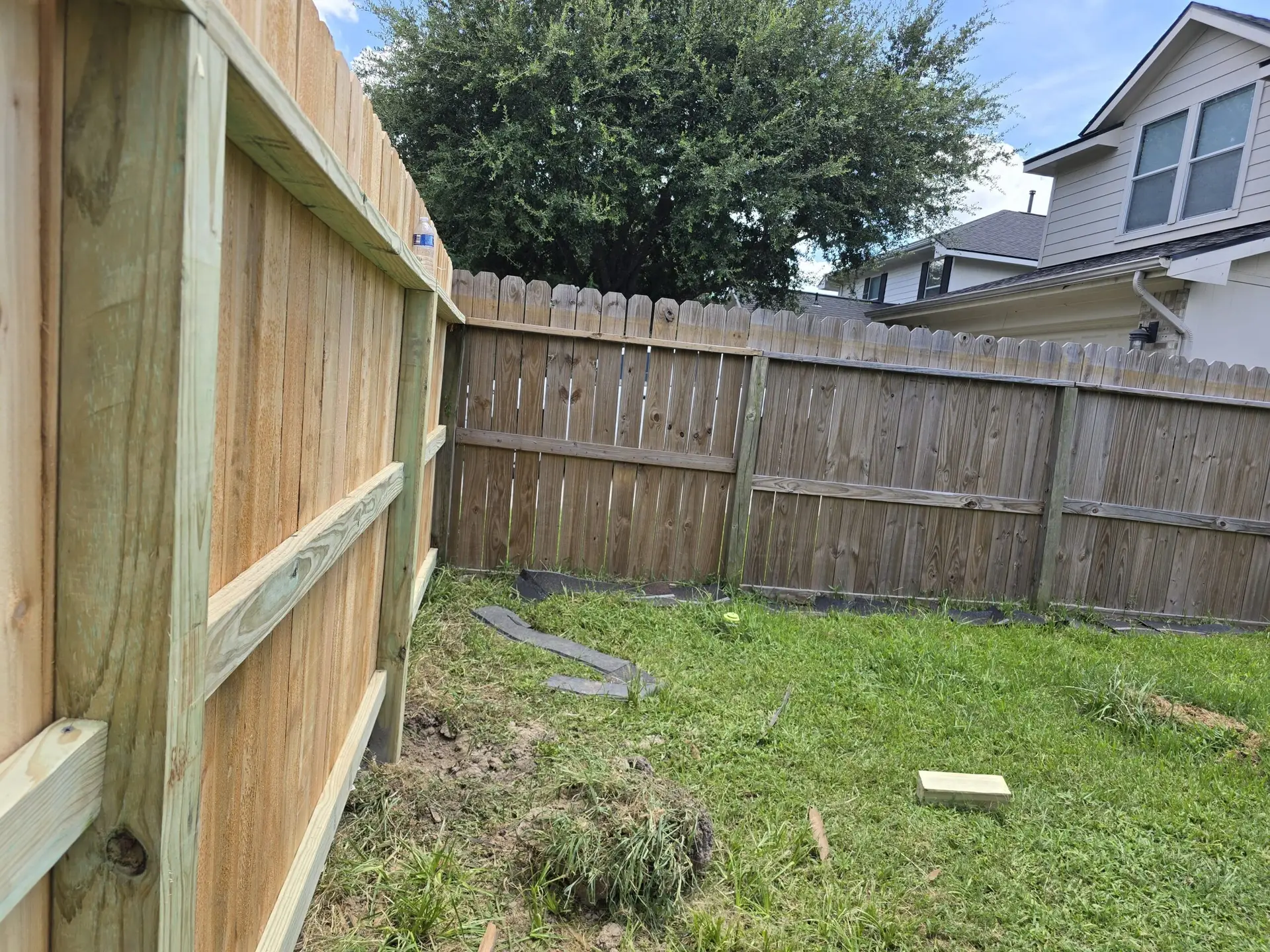 Backyard wood fence repair and installation project